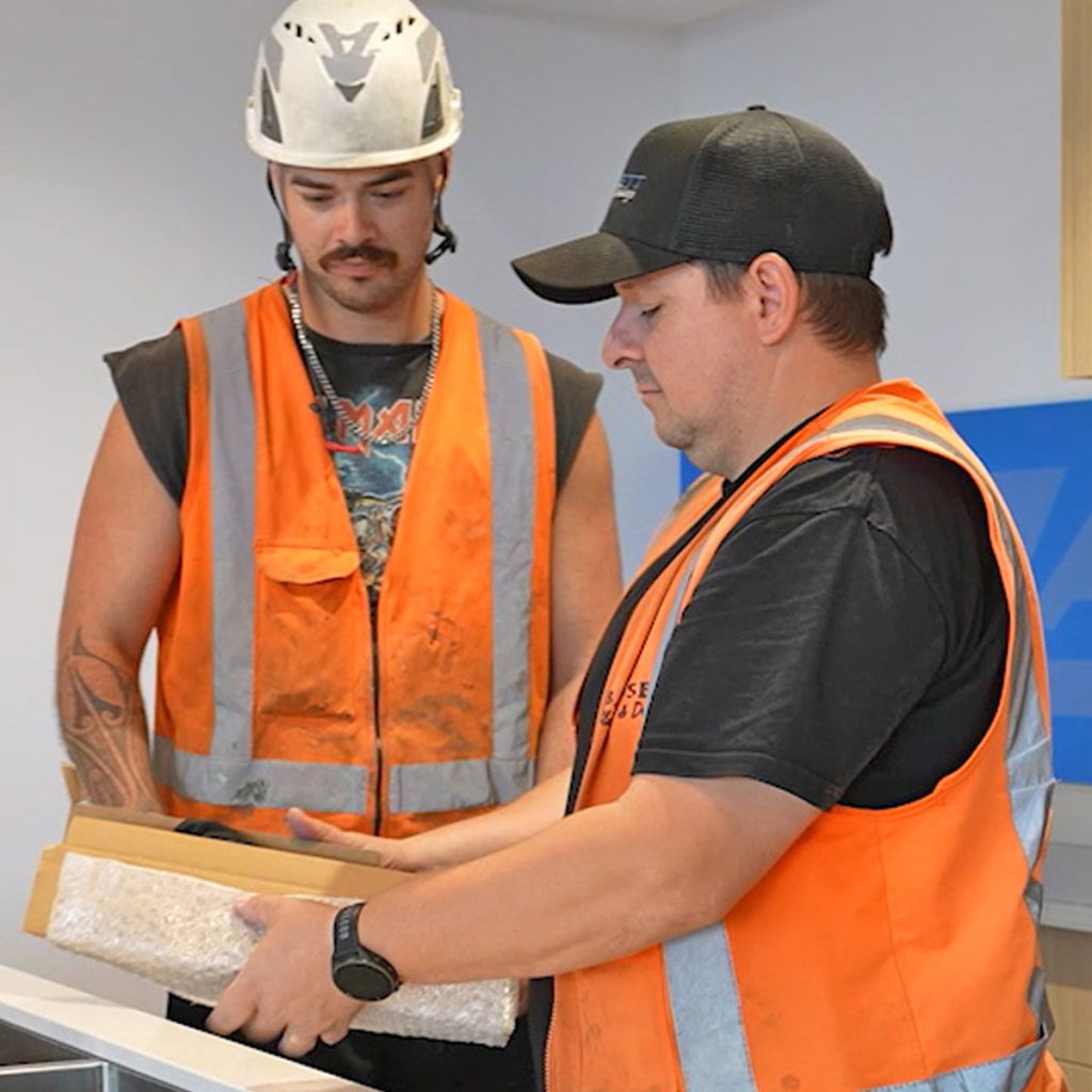 Trades workers reviewing materials on a construction site