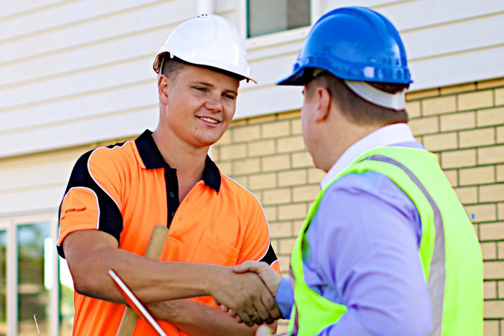 Apprentice and supervisor reviewing materials during on-site training